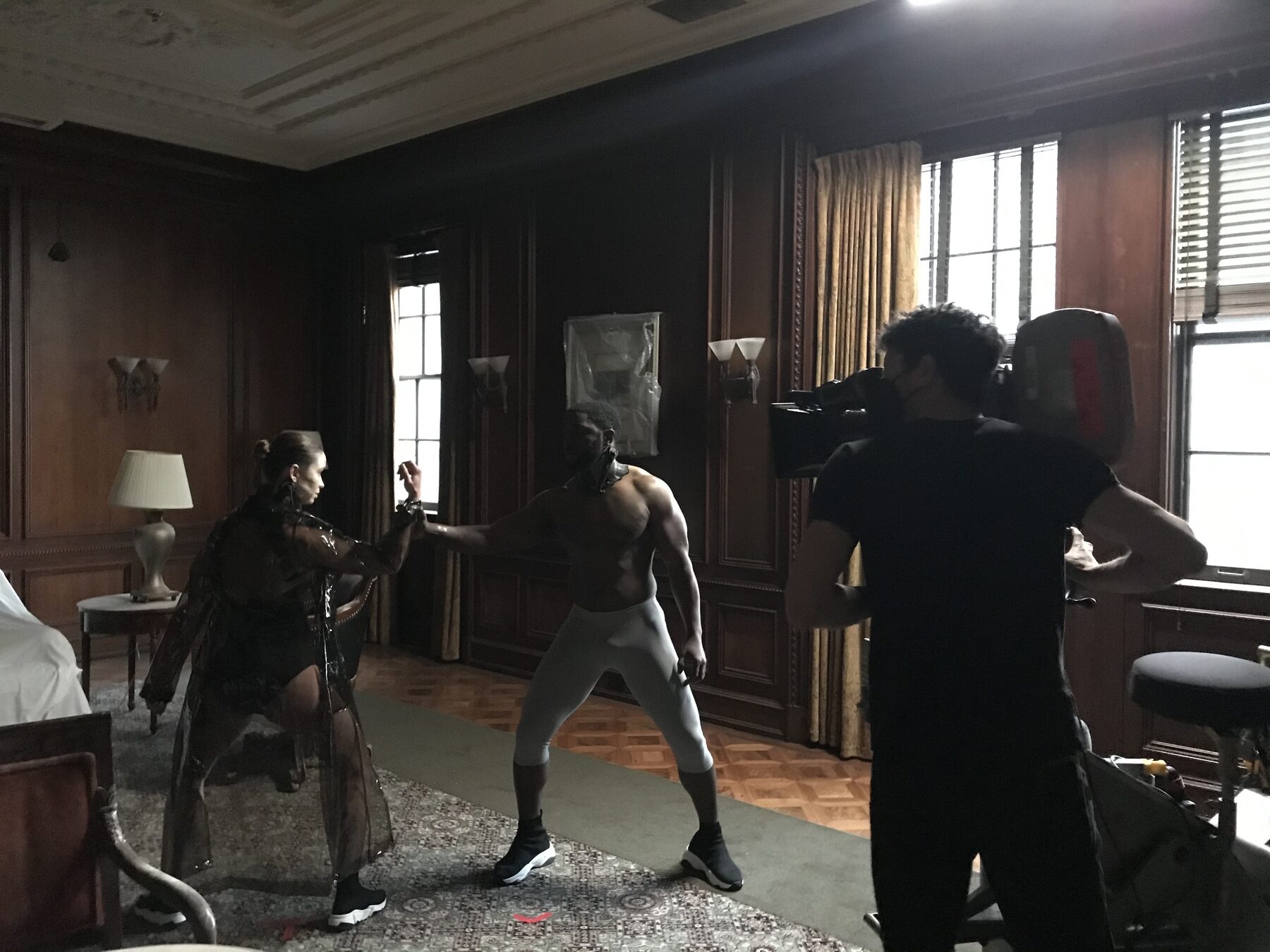 Stunt choreography being blocked in a period interior