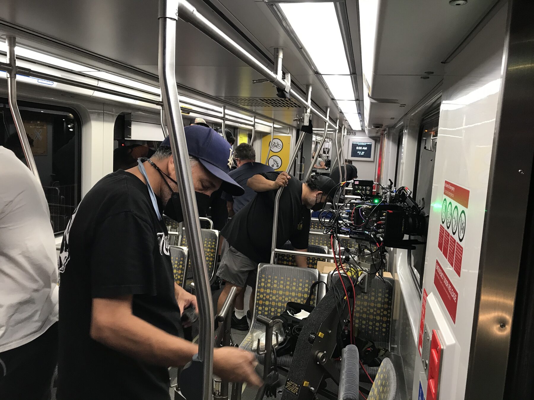 Film crew setting up inside a subway train car